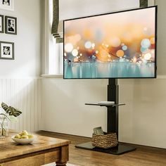 a flat screen tv sitting on top of a wooden table