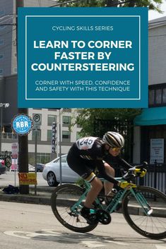 a man riding a bike down a street next to a blue sign that says learn to corner counters