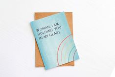 a card with the words woman, i am holding you in my heart on it