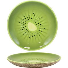 a green plate with a cut in half kiwi on the front and bottom, sitting next to it