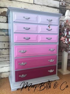 an old dresser painted in pink and purple