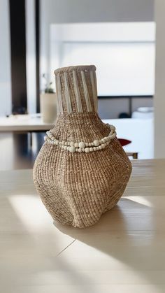 a vase sitting on top of a wooden table