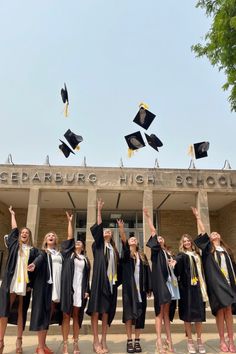 a group of graduates throwing their caps in the air on graduation day at cedarburg high school