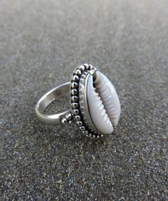 Cowrie Shell Rings / Silver Oxidized Rings / Statement Boho Rings / Seashell Ring / Handcrafted Cowrie Ring / Beach Jewelry / Mothers Gift / All rings sizes / Summer Beach Jewelry Metal:- 925 Sterling Silver Finish :- Silver Oxidized Stone:- Cowrie Shell Stone Shape : Natural Shell Ring Size - 5 To 12 Ring sizes available Benefit Of Cowrie:  They are used as a tool to save children from evil eyes and negative energies. *They are kept in the prayer room, cash box or money lockers for financial pr Cowrie Ring, Lakshmi Pooja, Shell Rings, Seashell Ring, Etsy Best Sellers, Summer Beach Jewelry, Oxidized Ring, Friendship Day Gifts, Cash Box