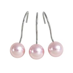 three pairs of pink pearls hanging from hooks on a pair of silver earwires