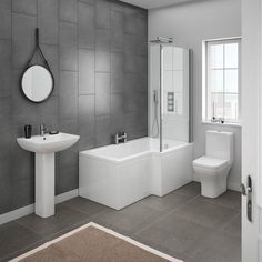 a bathroom with a sink, mirror and bathtub next to a wall mounted shower head