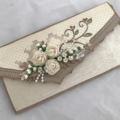 a close up of a card with flowers and laces on it's edge