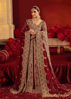 Pakistani Bridal Dress in Open Pishwas and Lehenga Style is a stunning attire in an alluring Red color. This embellished Pishwas Dress is available Online.