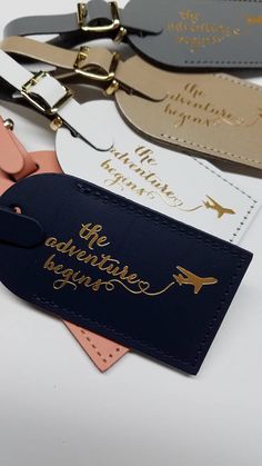 luggage tags with the words, the adventure begins and an airplane on them are shown