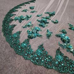 green sequins and sheer fabric on the floor