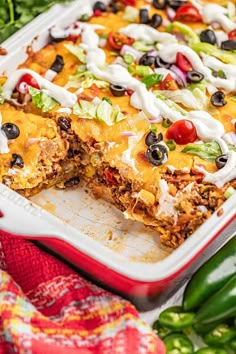 an enchilada casserole in a red dish on a table