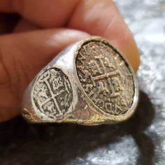 This coin ring has a very rough,  and antique finish to give it an old world feel. It's solid sterling silver, and there is a main center coin,  and a small coin on each side that gives this piece a very unique setting. The coins themselves are made from the silver bars recovered from the Atocha and comes with a certificate stating that. Treasure Coin, Key West Fl, Coin Ring, Ring Antique, Shipwreck, Silver Bars, Accessories Rings, Men's Rings, Antique Finish