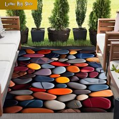 a living room area with a rug made out of rocks on the floor and potted plants in the background