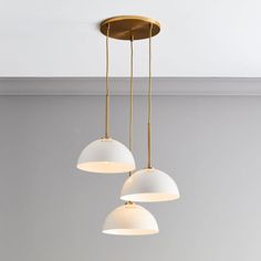 three lights hanging from a ceiling in a room