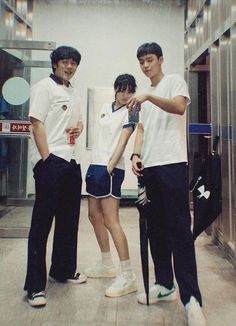 three young men standing next to each other