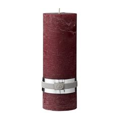 a red pillar candle with a metal ring around it