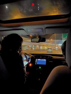 two people in a car at night driving