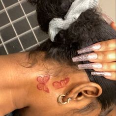 a woman with tattoos on her neck and behind her ear