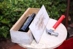 a toolbox with tools in it sitting on a small table next to some bushes