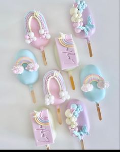 there are six pops with unicorns and rainbow decorations on them, all decorated in pastel colors