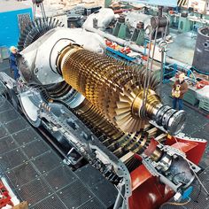 a large machine that is sitting on top of a metal floor in a factory area