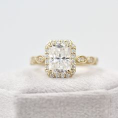 Radiant halo engagement ring on light grey velvet box Radiant Cut Engagement Ring, Radiant Cut Engagement Rings, Diamond Jewel, Radiant Diamond, Diamond Simulant, 18k Gold Ring, Bridal Bands, Engagement Ring Cuts, Rose Yellow