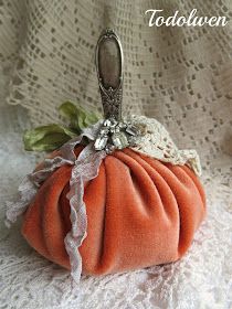 an orange purse sitting on top of a white lace covered table cloth with a silver metal handle