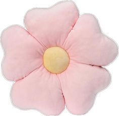 a pink flower shaped pillow sitting on top of a white surface