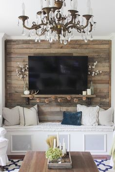 a living room filled with furniture and a flat screen tv mounted to the wall above it