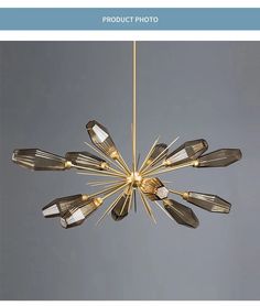 a chandelier hanging from the ceiling with many lights on it's sides