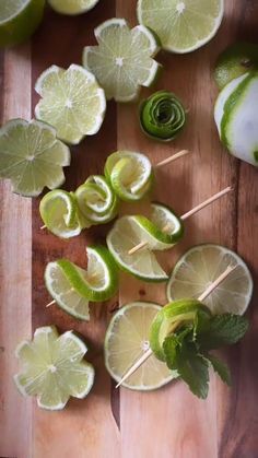 limes and limeade on a cutting board with toothpicks in the middle