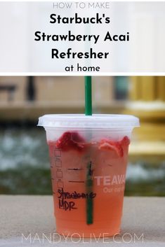 a drink in a plastic cup with strawberries on top and the text how to make starbucks's strawberry acai refresher at home