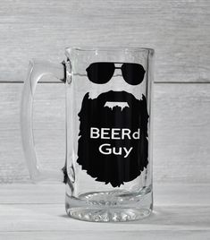 a glass mug with a beard and sunglasses on it that says beer guy in white lettering