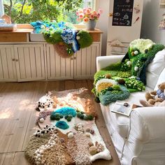 a living room filled with furniture and lots of stuffed animals on top of the floor