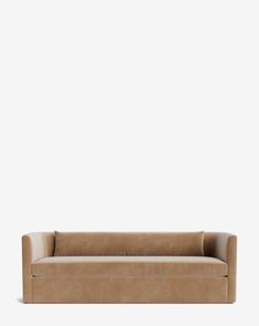 a tan leather couch against a white wall