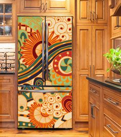 a colorful refrigerator in a kitchen with wooden cabinets