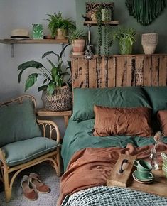 a bed room with a neatly made bed and lots of plants on the headboard