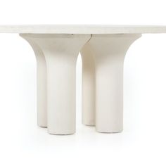 three white vases sitting next to each other on top of a table with two legs