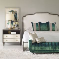 a green and white bedroom with a bed, night stand, nightstands and pictures on the wall