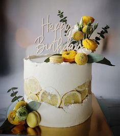 a white cake with lemons and flowers on top