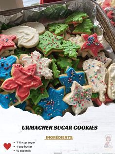 a basket full of decorated sugar cookies with sprinkles and stars on them