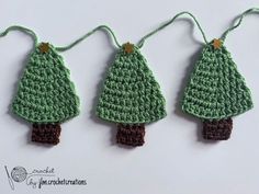 three crocheted christmas trees hanging from strings