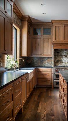 a kitchen with wooden cabinets and black counter tops, along with an oven in the center