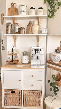 a kitchen with white cabinets and baskets on the counter