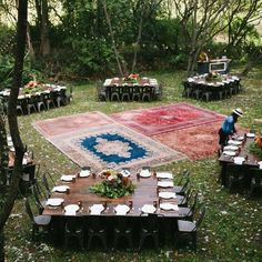 an outdoor area with tables and chairs set up for a dinner in the middle of it