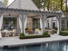 an outdoor dining area next to a pool