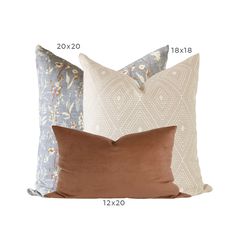 three pillows with different colors and sizes on them, one is brown, the other is blue