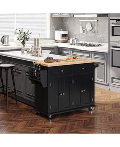 a large kitchen island with two stools in front of it and an oven on the other side