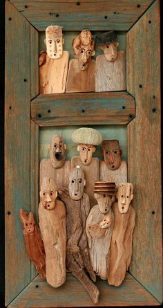 a group of carved wooden figures in a frame