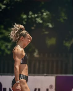 a woman standing on top of a tennis court holding a racquet in her hand